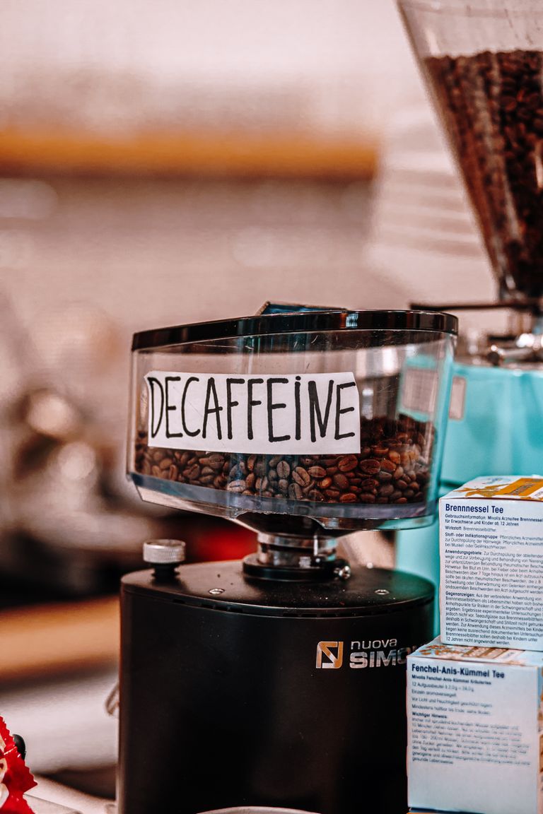 Close-up of a decaffeinated coffee grinder in a baku café, highlighting the beans and brewing atmosphere.
